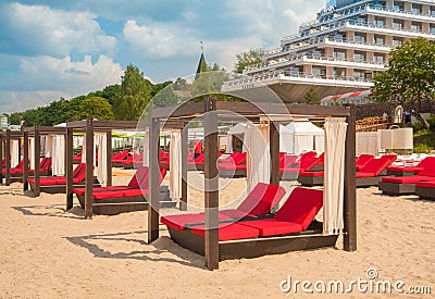 Empty sunbeds in a row on the sand beach Stock Photo