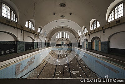 Empty swimming pool inside an old abandoned building Stock Photo