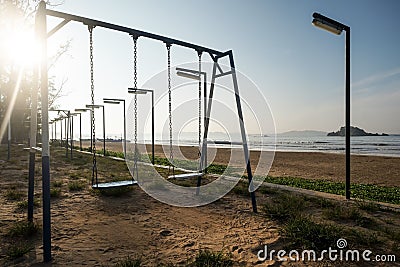 Empty swing at the playground on the beach of Weligama Stock Photo