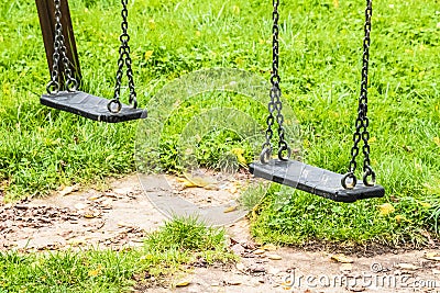 Empty swings at playground for child Stock Photo
