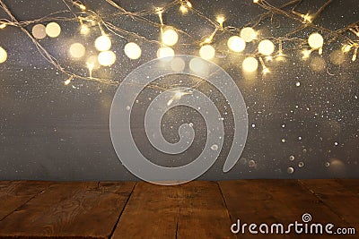 empty table in front of Christmas warm gold garland lights Stock Photo