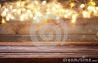 empty table in front of Christmas warm gold garland lights Stock Photo