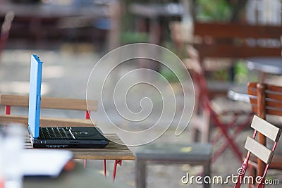 empty table seat in coffee shop with notepad on table Stock Photo