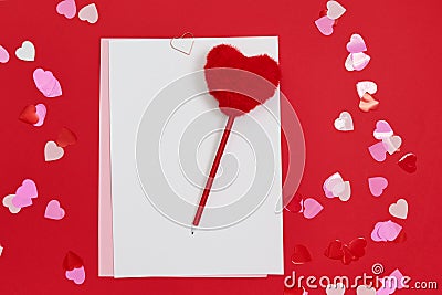 Empty template for romantic letters on red background. Red pen with fur heart shape. Stock Photo