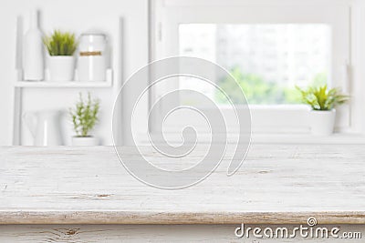 Empty textured wooden table and kitchen window shelves blurred background Stock Photo