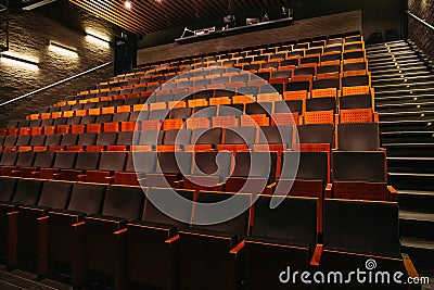 Empty theatre or cinema auditorium hall with rows of seats or chairs Stock Photo