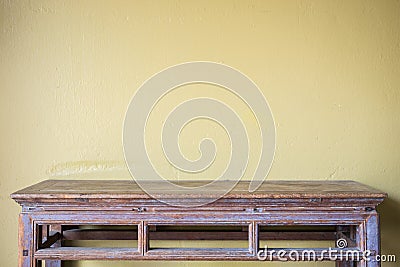 Empty top vintage wooden table and yellow cement wall background Stock Photo