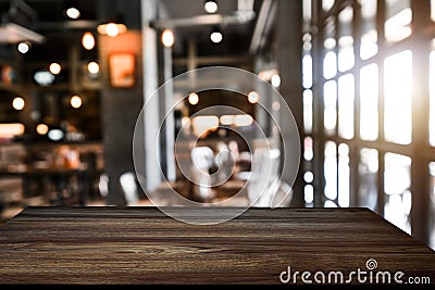 Empty top of wooden shelves on coffee shop ,tree front view background. For product display blur background Stock Photo