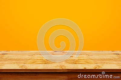 Empty top of wooden table on yellow background. Stock Photo