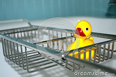 Empty tub with a yellow rubber duckie. Stock Photo