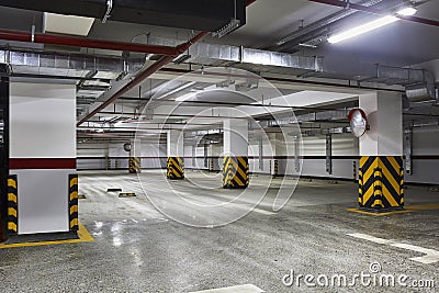 Empty business center underground parking lot interior with concrete stripe painted columns Stock Photo