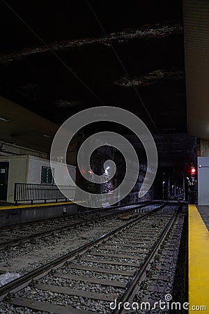 Empty underground train tunnel. Dark subway station. Editorial Stock Photo