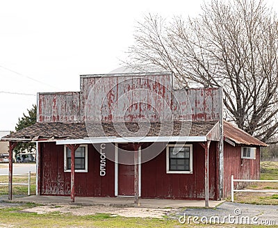 Empty unused abandoned deteriorated red wooden building Stock Photo