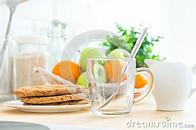 Empty Ñup, milk jug, cookies and fruit on the kitchen table. Making breakfast, good or healthy morning Stock Photo