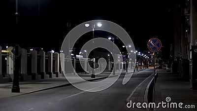 Empty urban street, night scenery in the city with street lamps on black sky background. Stock footage. Late evening Stock Photo