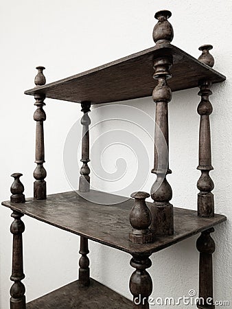 Vintage black wooden bookstand against white wall Stock Photo