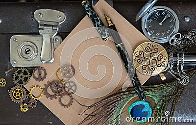An empty vintage card for a close-up message, with gears pen lock and ornaments lie on a dark background. Can be used for Stock Photo