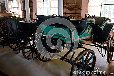 Empty vintage horse carriages parked in garage Editorial Stock Photo