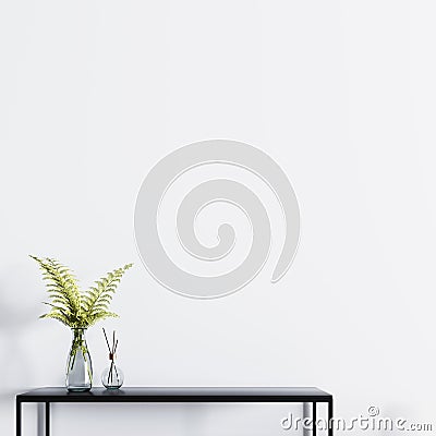 Empty wall for mockup poster with table and plant in a glass vase. Stock Photo