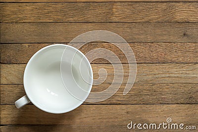 Empty white cup for tea or coffee on wooden table. Copy space. Flat lay. Top view. Unfilled mug Stock Photo