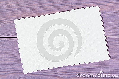 Empty white figured paper card on a light-violet wooden background Stock Photo