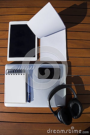 Empty white notepad with mobile phone, laptop, headphones and tablet Stock Photo