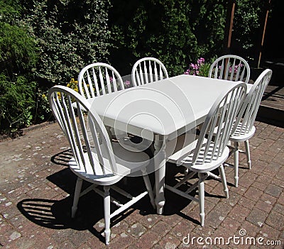 Empty white outdoor patio chairs and table in garden Stock Photo