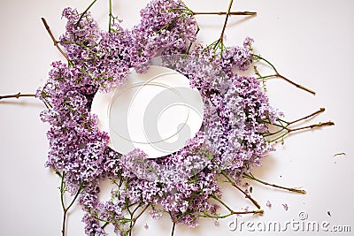 Empty white oval frame with lilac branches. blank with flowers. mockup card for spring womans day Stock Photo