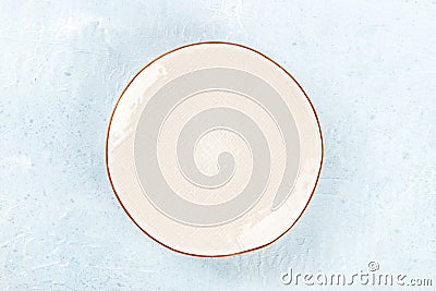 An empty white plate with a gold rim, overhead flat lay shot Stock Photo