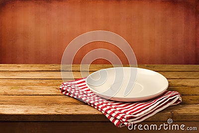 Empty white plate on wooden table Stock Photo