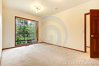 Empty white room with wood door and beige carpet. Stock Photo