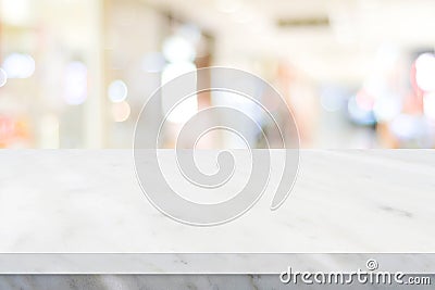 Empty white table top, counter, desk over blur perspective store with bokeh light background, White marble stone table, shelf and Stock Photo