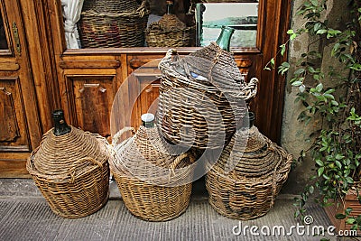 Empty wine bottles in wicker baskets Stock Photo