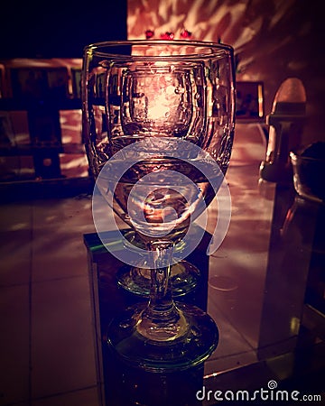 Empty wineglass reflecting lights Stock Photo