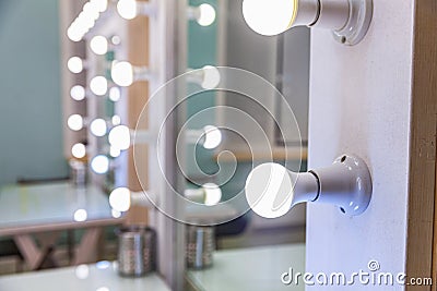 Empty woman makeup place with mirror and bulbs. Workplace makeup artist in modern makeup room. Barbershop interior Stock Photo