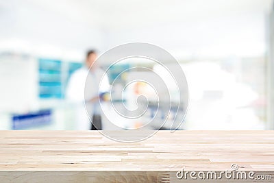 Empty wood counter top on blur pharmacy background Stock Photo