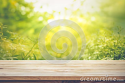 Empty of wood table top on blur of fresh green abstract from garden Stock Photo