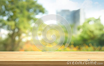 Empty of wood table top on blur of fresh green garden with city town backgrounds Stock Photo