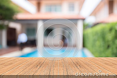 Empty wood table top on blurred background at swimming pool garden Stock Photo