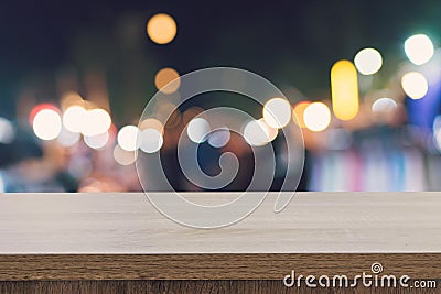 Empty wood table top for product display montage and blurred bokeh night. Stock Photo