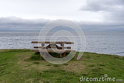 Empty wooden bench with view over fjord Stock Photo