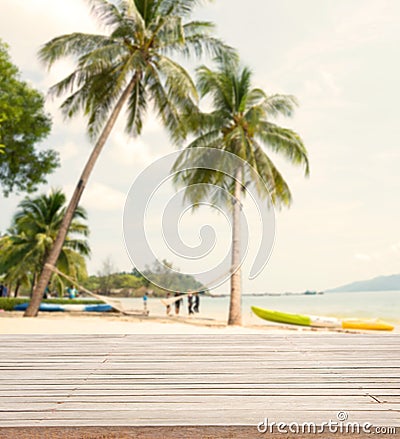 Empty wooden with coconut tree and sea background for product display. Stock Photo