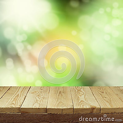 Empty wooden deck table with foliage bokeh background for product display montage. Spring or summer Stock Photo