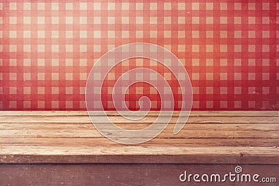 Empty wooden deck table over checked red wallpaper. Vintage kitchen interior. Stock Photo