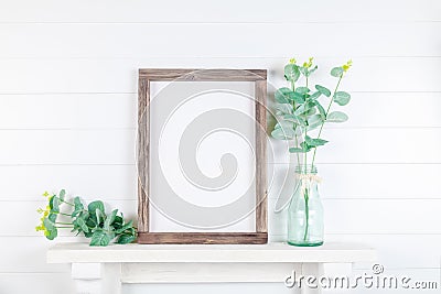 Empty wooden frame on a light wall Stock Photo