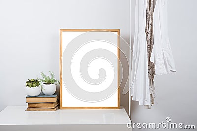Empty wooden picture frame on the table, art print mock-up Stock Photo