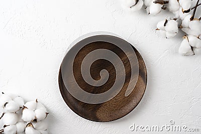 Empty wooden plate with cotton flowers on white background Stock Photo