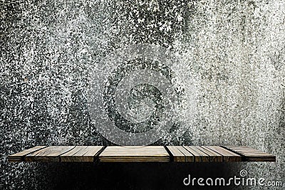 Empty wooden shelf counter on grungy concrete wall for display Stock Photo