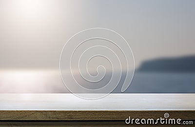 Art Empty wooden table on blurred background of sunny seaside view Stock Photo