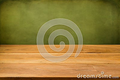 Empty wooden table over grunge green background. Stock Photo